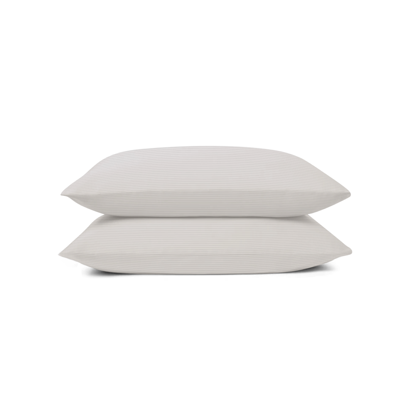 Two pillows on top of each other on a white background
