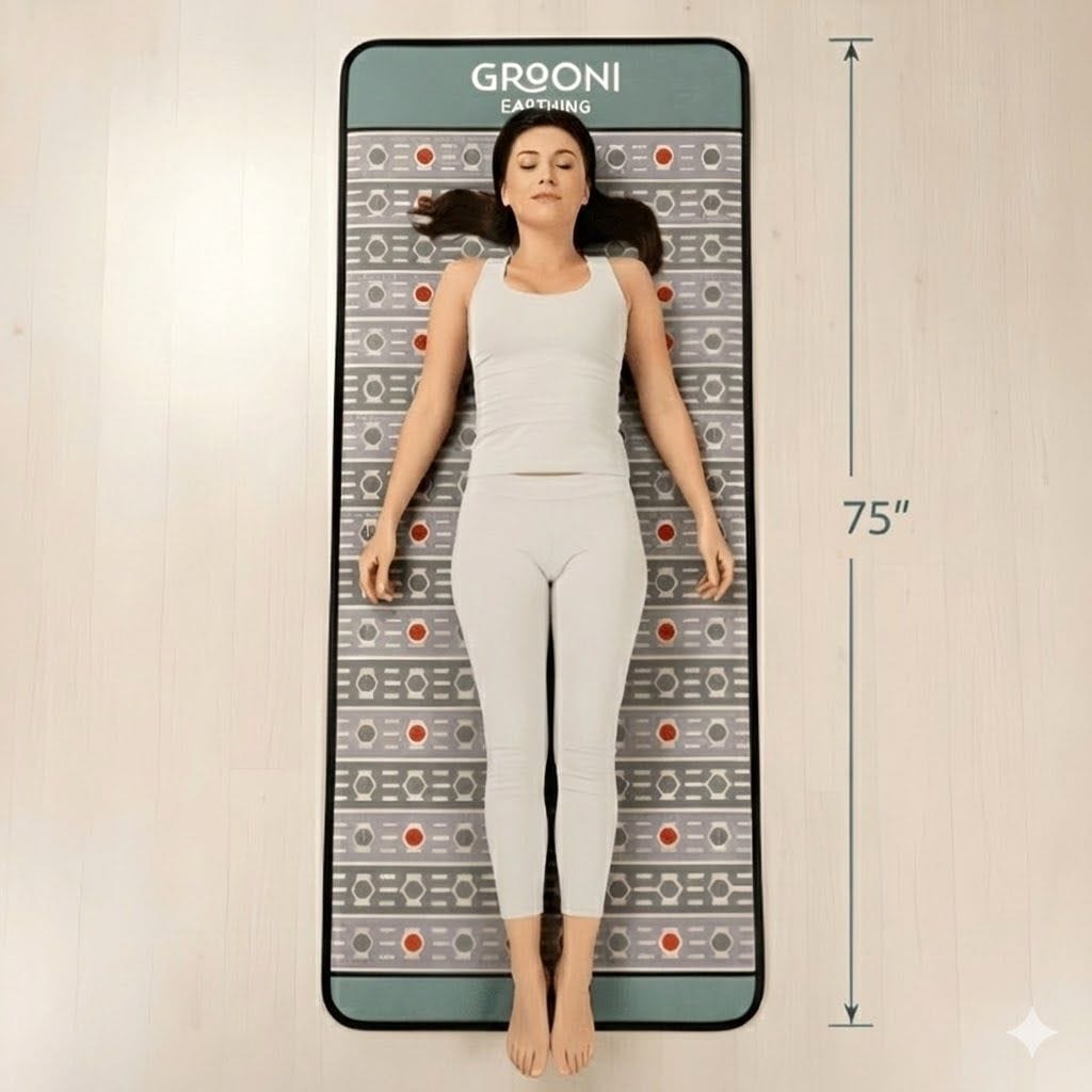 Woman lying on a Grooni PEMF mat with dimensions indicated.