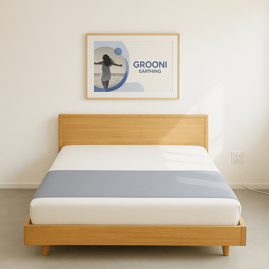 Wooden bed with white mattress and gray grounding half sheet in a room with a 'GROONI' framed picture on the wall.