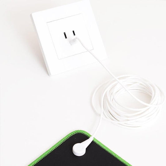 A mouse pad with a power cord attached to it